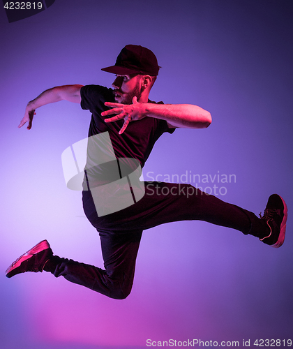 Image of The silhouette of one hip hop male break dancer dancing on colorful background