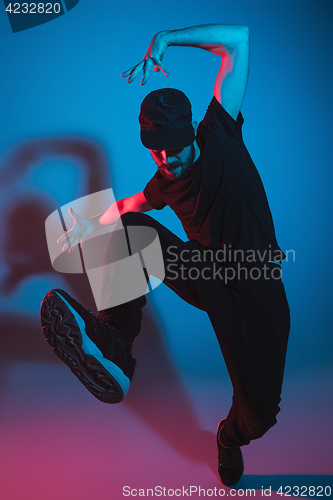 Image of The silhouette of one hip hop male break dancer dancing on colorful background