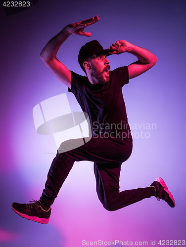 Image of The silhouette of one hip hop male break dancer dancing on colorful background