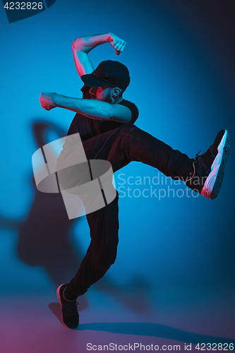 Image of The silhouette of one hip hop male break dancer dancing on colorful background