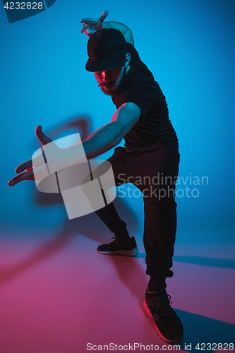 Image of The silhouette of one hip hop male break dancer dancing on colorful background