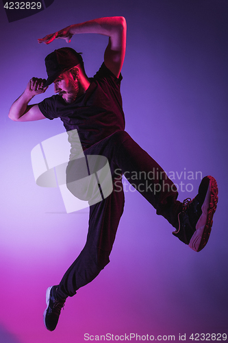 Image of The silhouette of one hip hop male break dancer dancing on colorful background