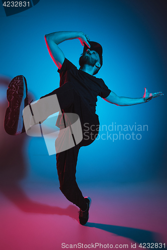 Image of The silhouette of one hip hop male break dancer dancing on colorful background