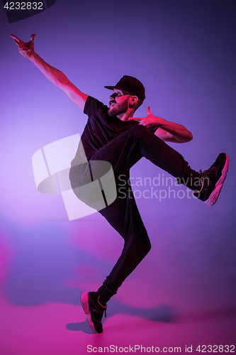 Image of The silhouette of one hip hop male break dancer dancing on colorful background
