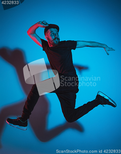 Image of The silhouette of one hip hop male break dancer dancing on colorful background