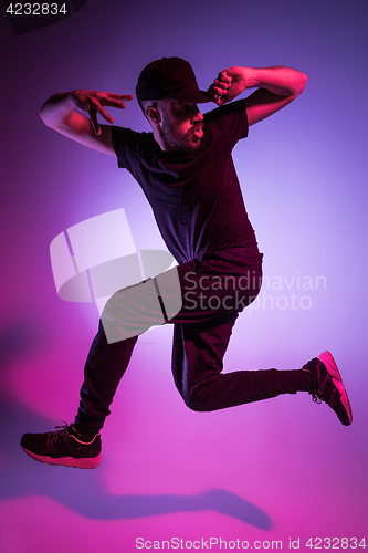 Image of The silhouette of one hip hop male break dancer dancing on colorful background