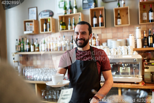 Image of man or waiter serving customer at coffee shop