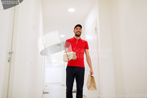 Image of man delivering coffee and food to customer home