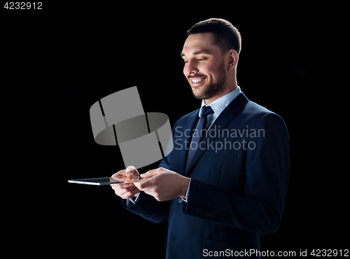 Image of businessman in suit with transparent tablet pc