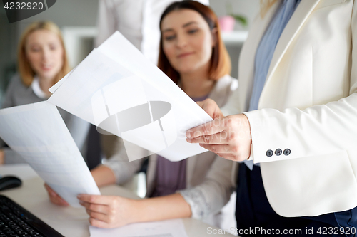 Image of businesswomen with papers in office