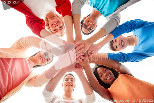 Image of international group of women with hands together