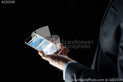 Image of close up of businessman with charts on smartphone