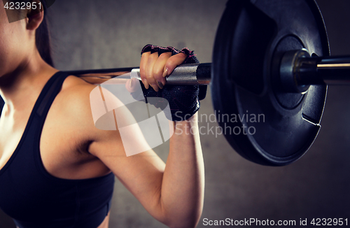 Image of close up of woman with barbell in gym