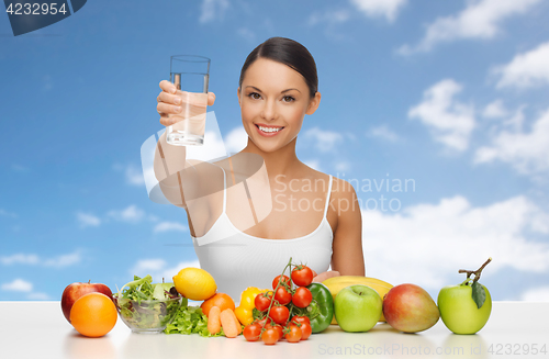 Image of happy woman with glass of water and healthy food