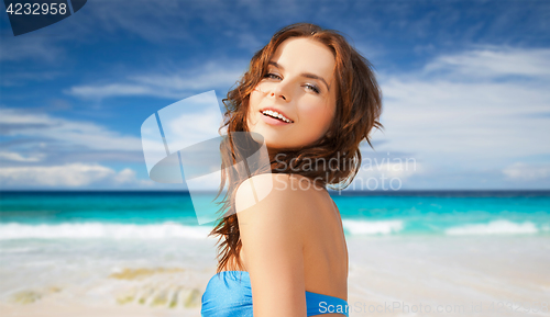 Image of happy woman in bikini swimsuit on tropical beach