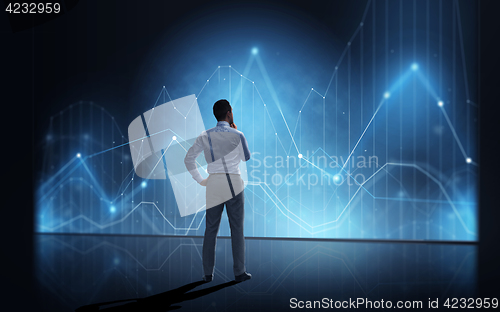 Image of businessman looking at virtual diagram chart