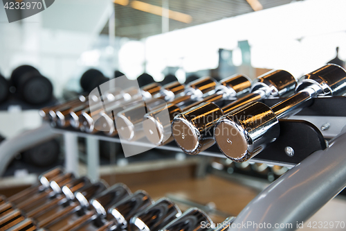 Image of dumbbells and sports equipment in gym