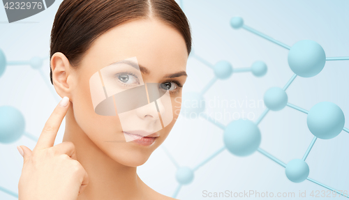 Image of beautiful young woman face with molecules