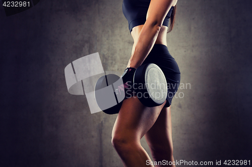 Image of close up of woman with dumbbell in gym