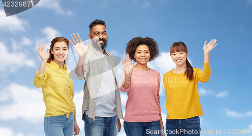 Image of international group of happy people waving hands