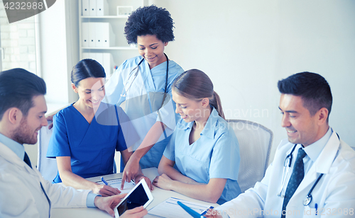 Image of group of happy doctors meeting at hospital office