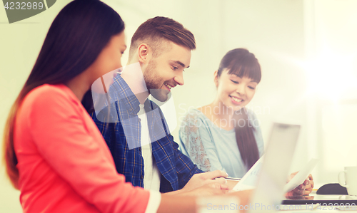 Image of happy creative team or students working at office