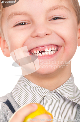 Image of Little boy with fresh yellow apple