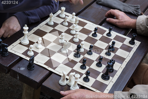 Image of Close up of senior men playing chess.