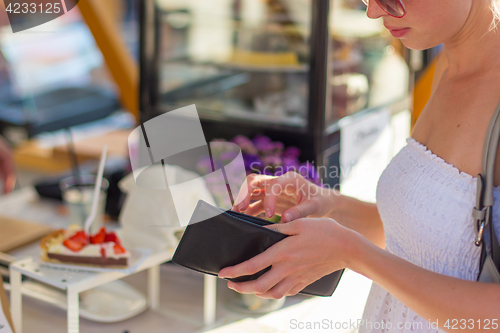 Image of Woman buying meal at street food festival.