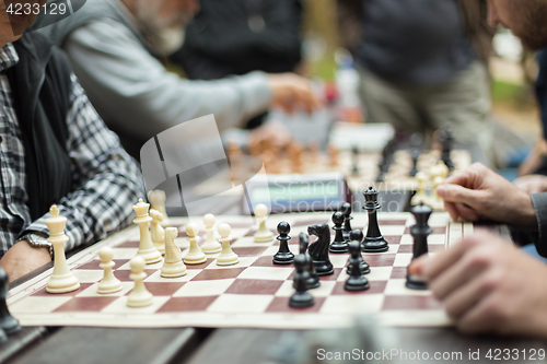 Image of Close up of senior men playing chess.