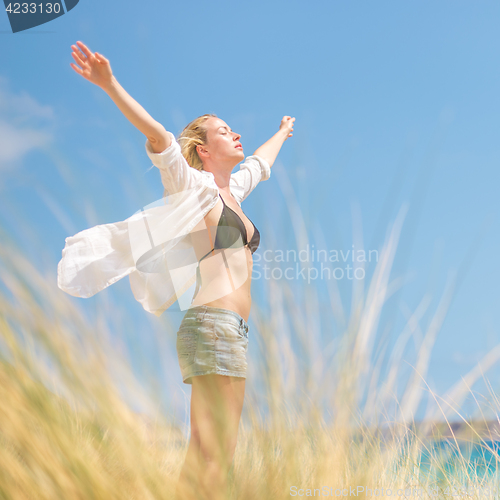 Image of Free Happy Woman Enjoying Sun on Vacations.