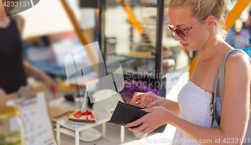 Image of Woman buying meal at street food festival.