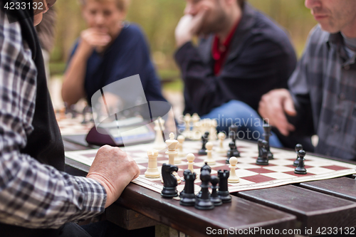 Image of Close up of senior men playing chess.