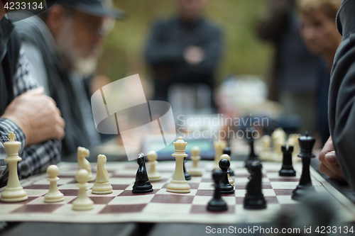 Image of Close up of senior men playing chess.