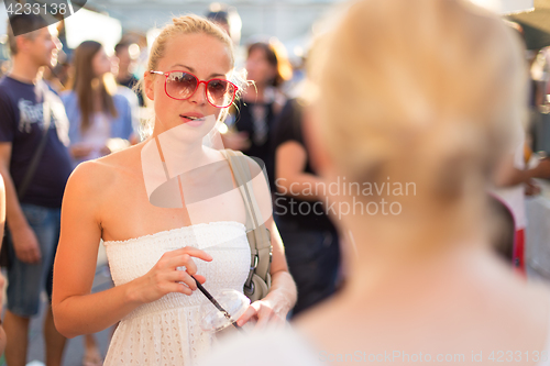 Image of Female friends enjoying a conversation on market.