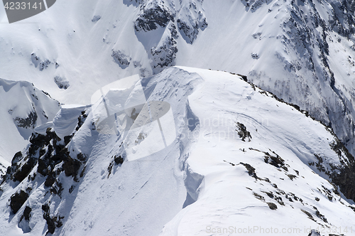 Image of Snow cornice in high winter mountains in nice sun day