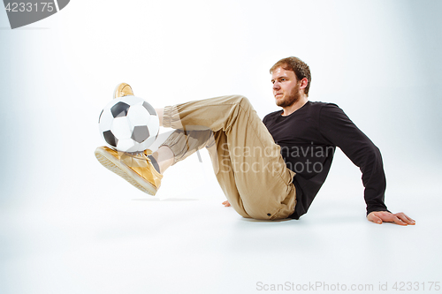 Image of The portrait of fan with ball on gray background