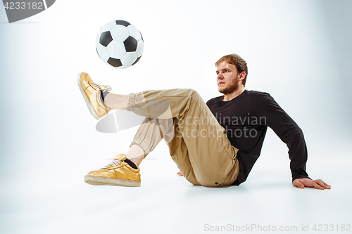 Image of The portrait of fan with ball on gray background