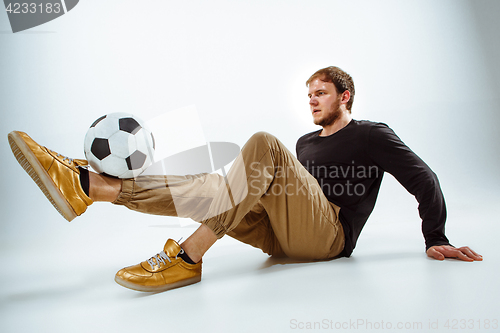 Image of The portrait of fan with ball on gray background