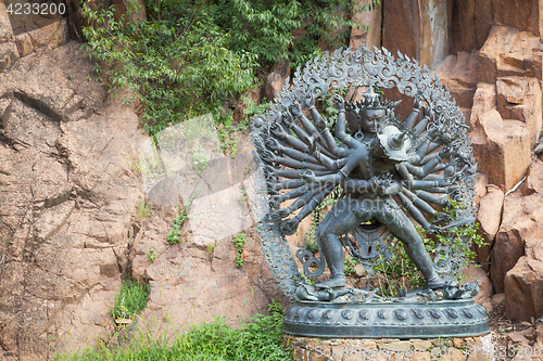 Image of Tantric Deities statue in Ritual Embrace located in a mountain g