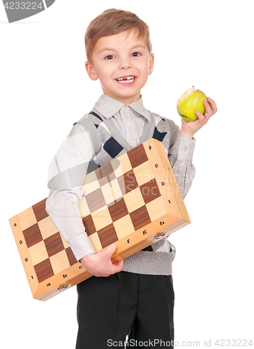 Image of Boy with chessboard and apple