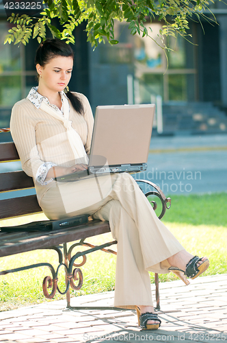 Image of Business woman in summer park