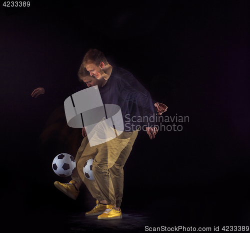 Image of A portrait of a fan with ball on gray studio background. Freestile