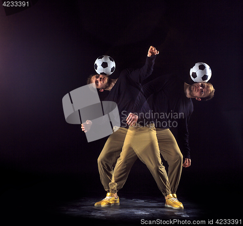 Image of A portrait of a fan with ball on gray studio background. Freestile