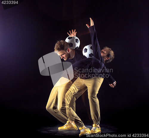 Image of A portrait of a fan with ball on gray studio background. Freestile