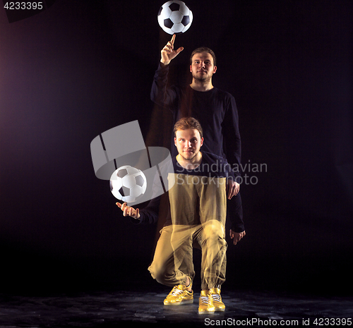 Image of A portrait of a fan with ball on gray studio background. Freestile