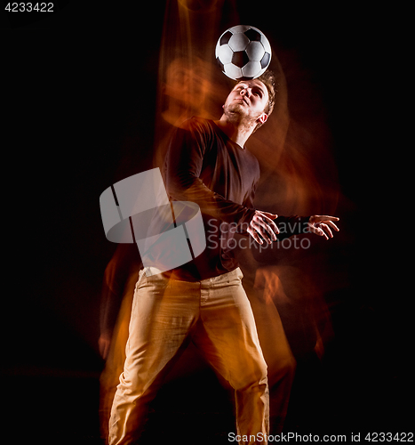 Image of A portrait of a fan with ball on gray studio background. Freestile