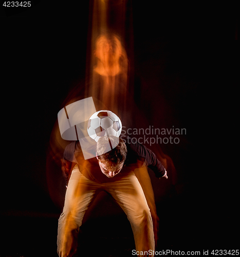 Image of A portrait of a fan with ball on gray studio background. Freestile