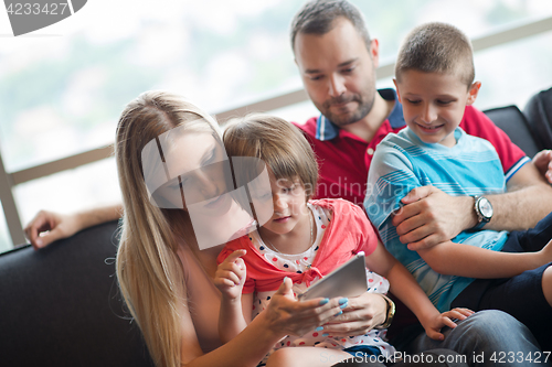 Image of happy young couple spending time with kids