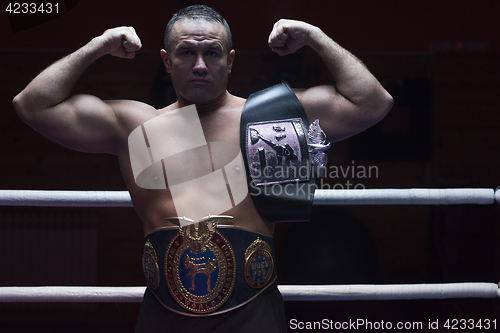 Image of kick boxer with his championship belt